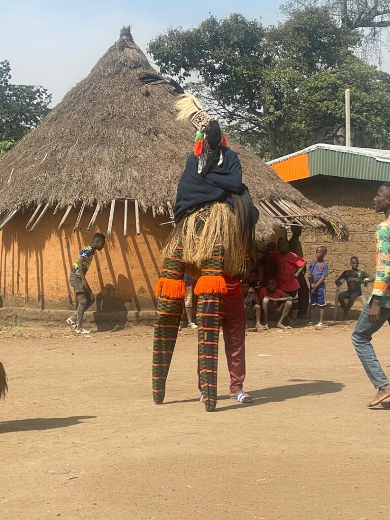 Bailarín de máscara sobre zancos en un pueblo de Costa de Marfil
