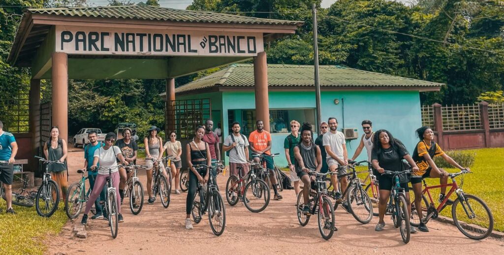 A group of cyclists at the entrance to Banco National Park, Abidjan